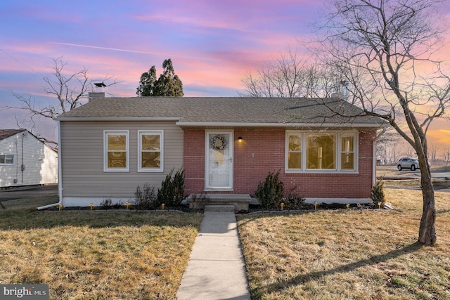 view of front of house with a yard