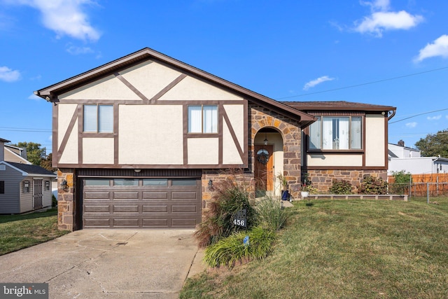 tudor-style house featuring a garage and a front yard