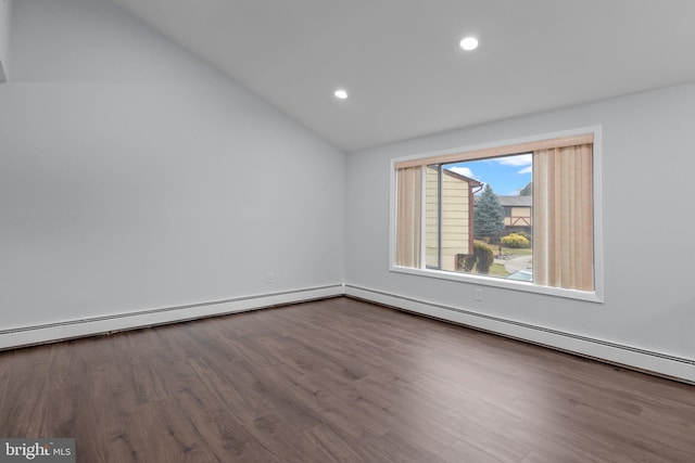 empty room featuring wood-type flooring, vaulted ceiling, and a baseboard radiator