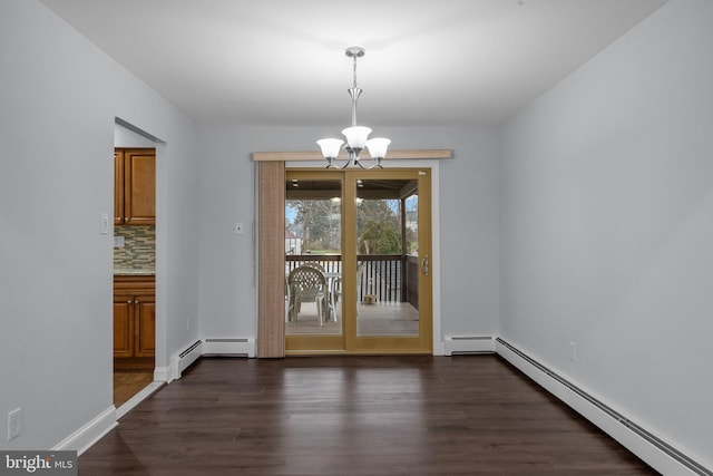 unfurnished dining area featuring an inviting chandelier, dark wood-type flooring, and a baseboard heating unit