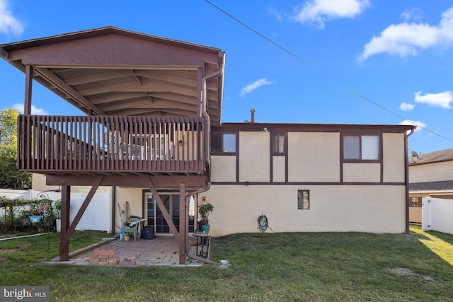 rear view of property with a yard, a patio area, and a deck