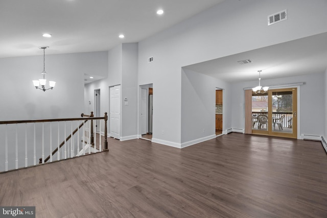 empty room with dark wood-type flooring, a baseboard radiator, high vaulted ceiling, and a notable chandelier