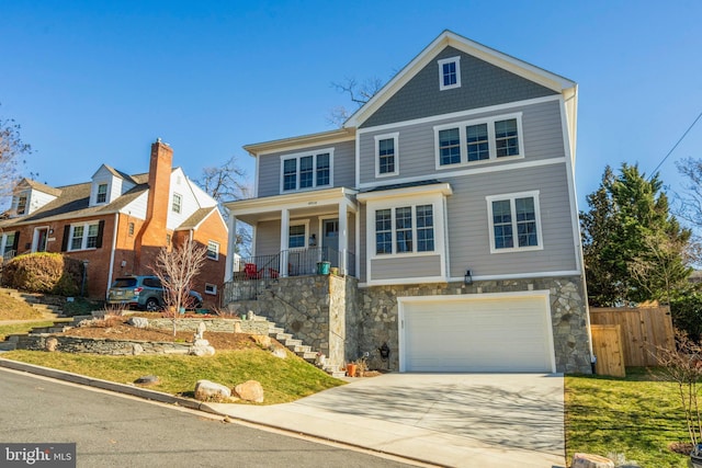 view of front of house featuring stairway, fence, a garage, stone siding, and driveway