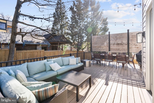 deck featuring outdoor dining area, outdoor lounge area, and fence