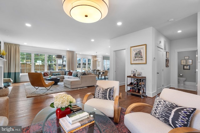 living room with recessed lighting, baseboards, and wood finished floors