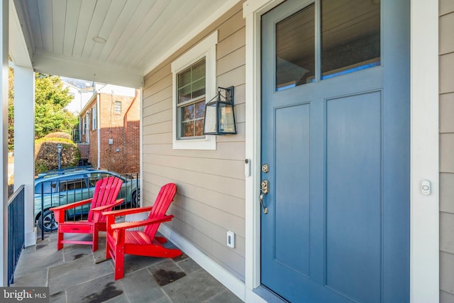 view of exterior entry with a porch