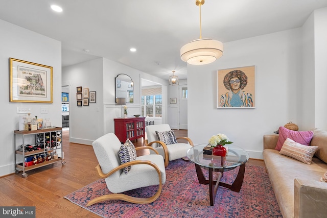 living room with baseboards, wood finished floors, and recessed lighting