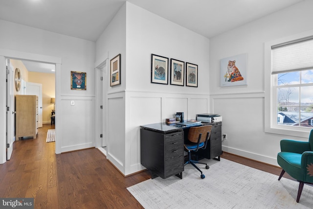 office space featuring a wainscoted wall, baseboards, dark wood finished floors, and a decorative wall