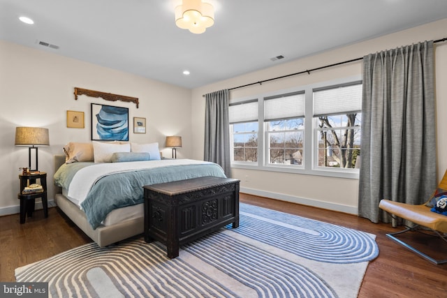 bedroom featuring recessed lighting, wood finished floors, visible vents, and baseboards