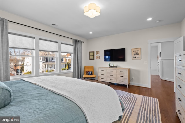 bedroom featuring baseboards, visible vents, dark wood finished floors, and recessed lighting