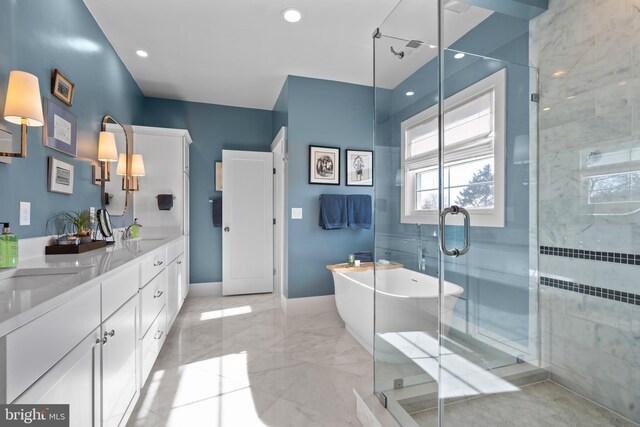 full bath with a stall shower, marble finish floor, a sink, and double vanity