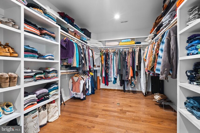 spacious closet with visible vents and wood finished floors