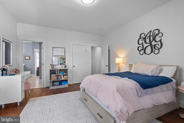 bedroom featuring dark wood finished floors and a closet