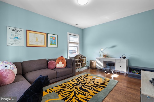 living room with wood finished floors and visible vents