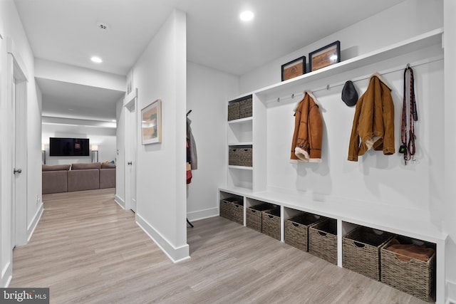 mudroom featuring baseboards, wood finished floors, and recessed lighting