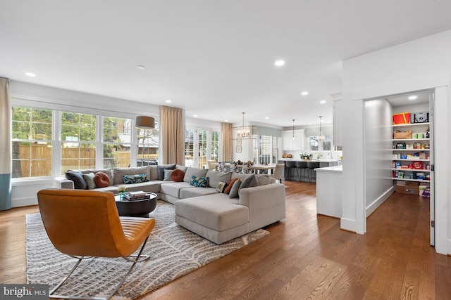 living room with a chandelier, wood finished floors, and recessed lighting