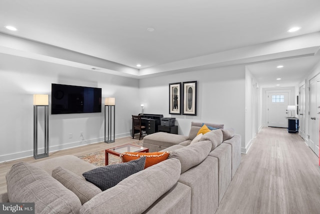 living room featuring baseboards, recessed lighting, and light wood-style floors