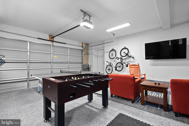 rec room with a garage and speckled floor