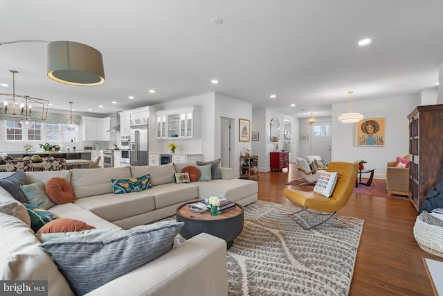 living room featuring a healthy amount of sunlight, dark wood finished floors, and recessed lighting