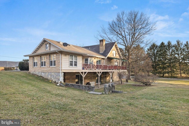 rear view of house with a yard and a wooden deck