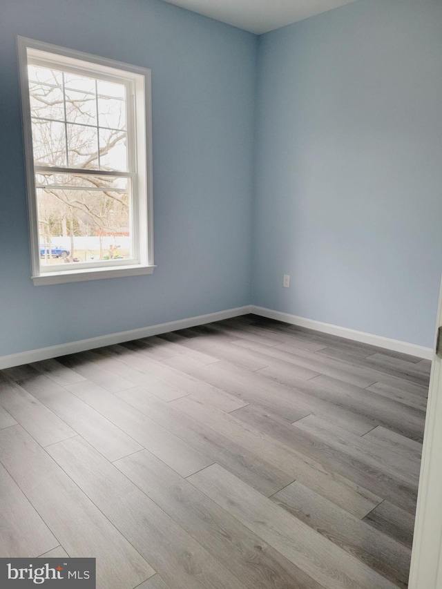 spare room with light wood-type flooring