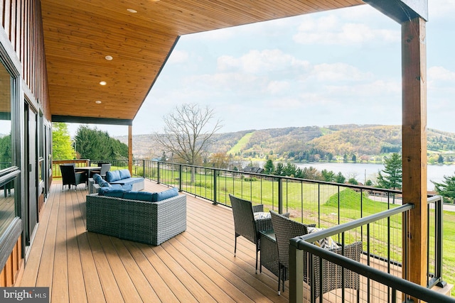 wooden deck featuring outdoor lounge area and a water view