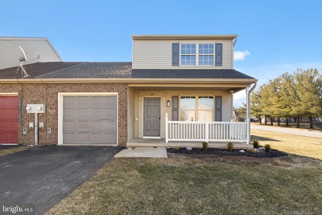 front facade with a garage, a front yard, and covered porch