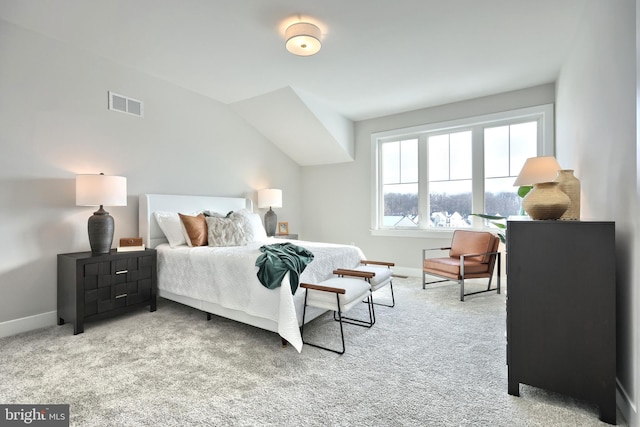 bedroom featuring visible vents, light carpet, and baseboards