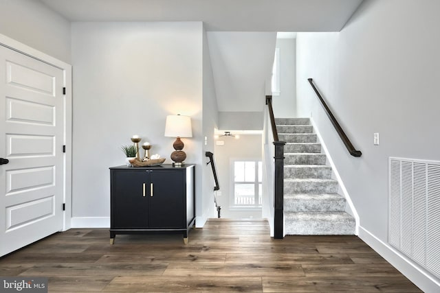 interior space with baseboards, visible vents, and wood finished floors