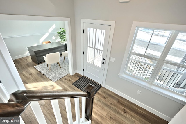 doorway featuring wood finished floors and baseboards