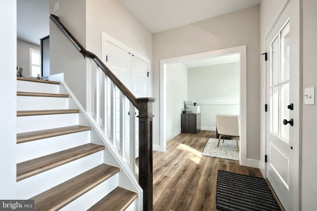 interior space with wood finished floors and baseboards