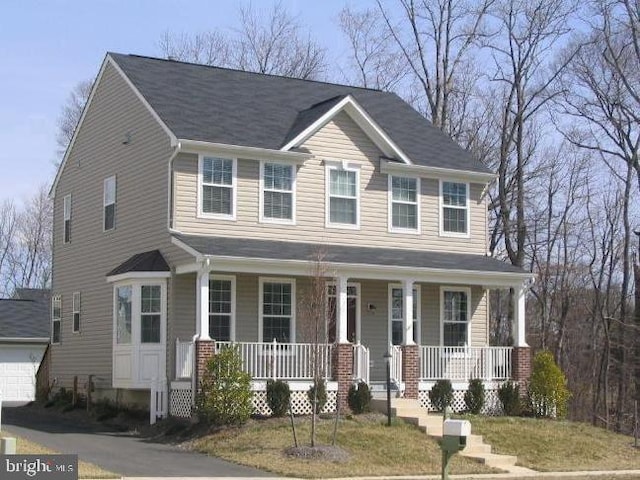 view of front of house with a porch and a garage