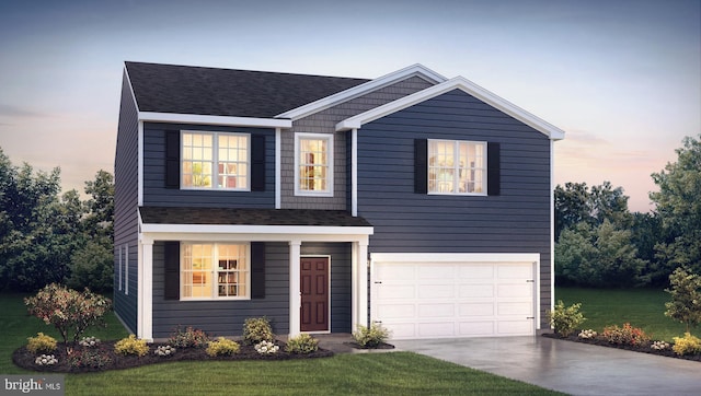 view of front of house with a garage and a yard