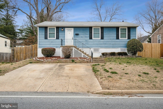 view of front of home featuring fence