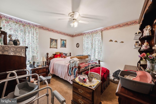 bedroom with a ceiling fan and carpet