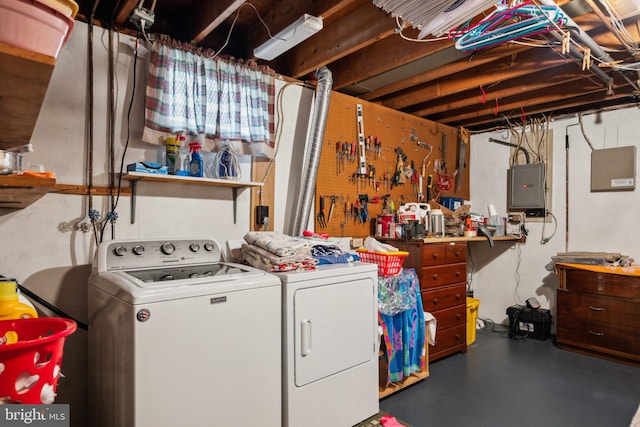 laundry room featuring laundry area, electric panel, washer and clothes dryer, and a workshop area