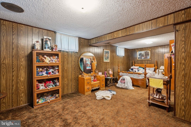 carpeted bedroom with wood walls and a textured ceiling