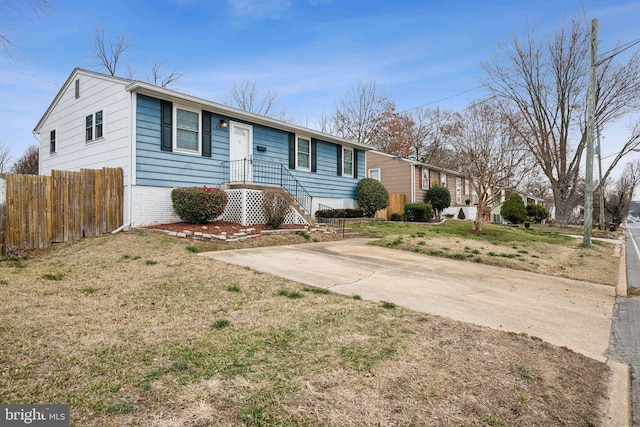 ranch-style home with fence, a front lawn, and brick siding