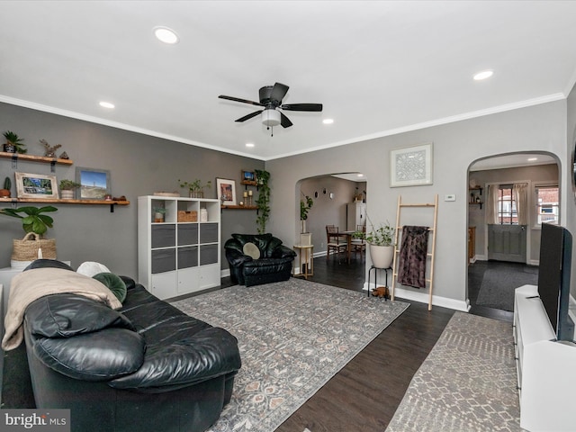 living room featuring ceiling fan, crown molding, and dark hardwood / wood-style floors