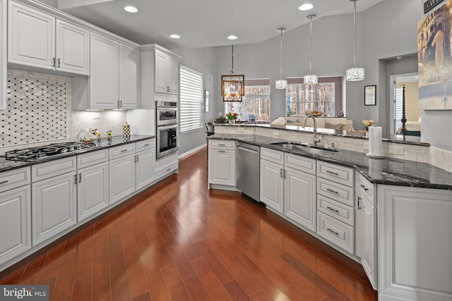 kitchen with white cabinets, appliances with stainless steel finishes, sink, and pendant lighting