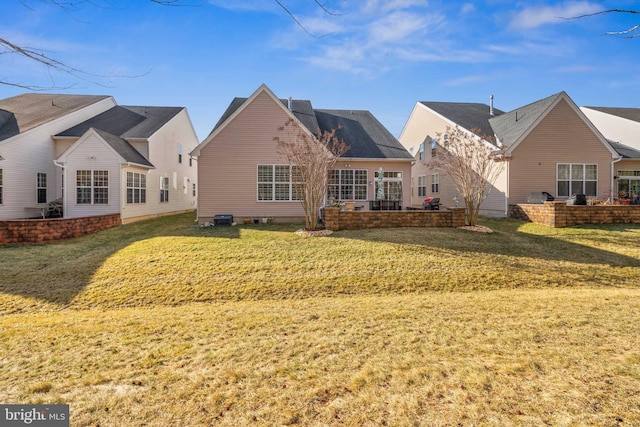 rear view of house featuring a yard