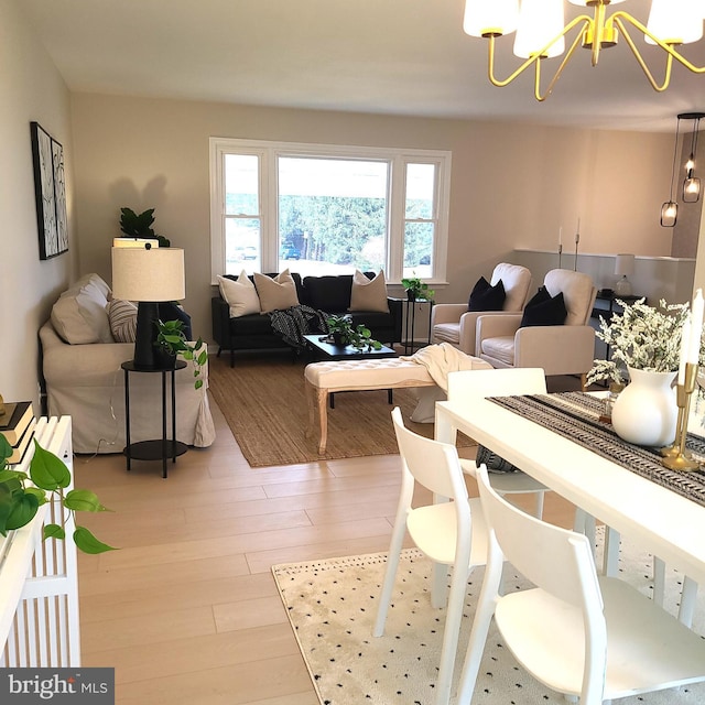 living area with a chandelier and light wood-type flooring