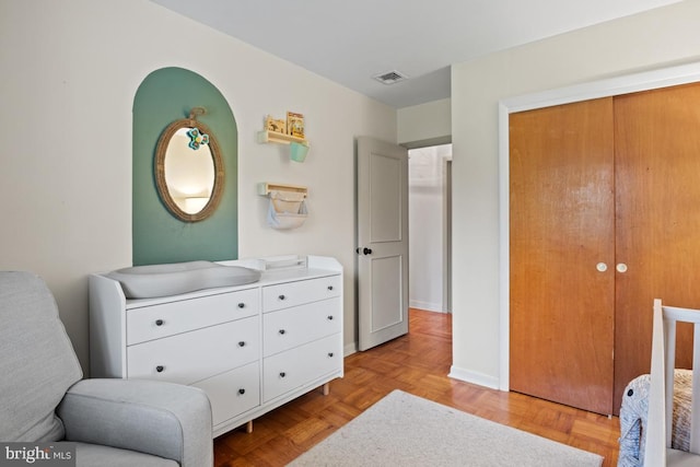 bedroom with light parquet flooring