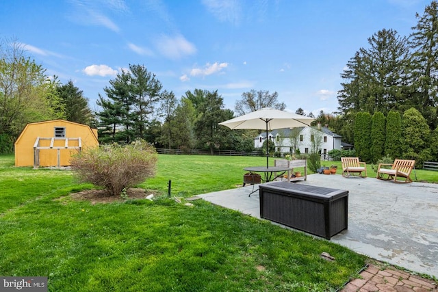 view of yard featuring a storage unit and a patio area