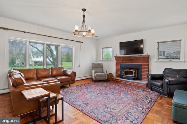 living room with light parquet flooring, a brick fireplace, a baseboard heating unit, and a chandelier