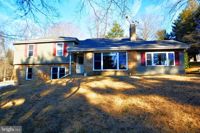 back of house with a lawn