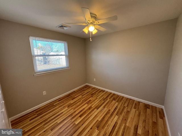 unfurnished room with light wood-type flooring, visible vents, ceiling fan, and baseboards