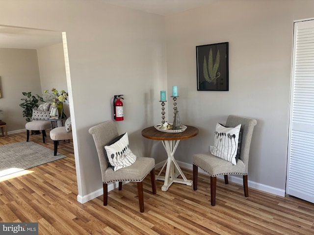 living area featuring light wood-style flooring and baseboards