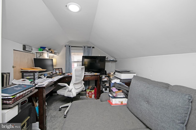 carpeted office space with vaulted ceiling