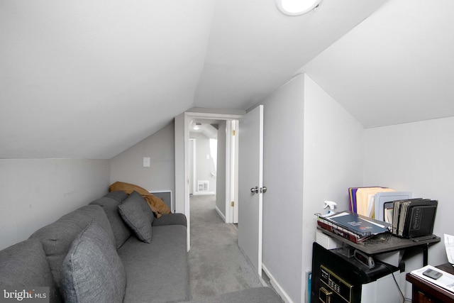 interior space with lofted ceiling, baseboards, and light colored carpet